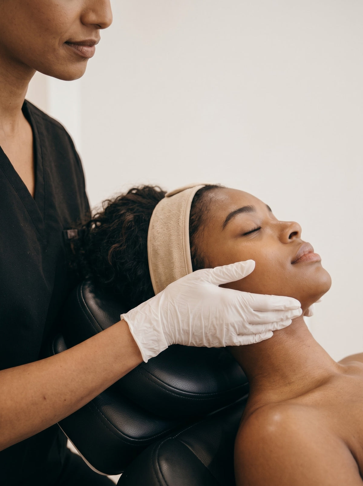Esthetician performing a facial treatment on a client with radiant skin